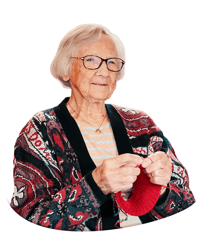 Grandma knitting a red beanie