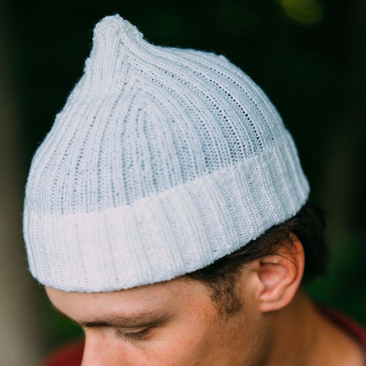 Hand knit pointy wool beanie, white, close up