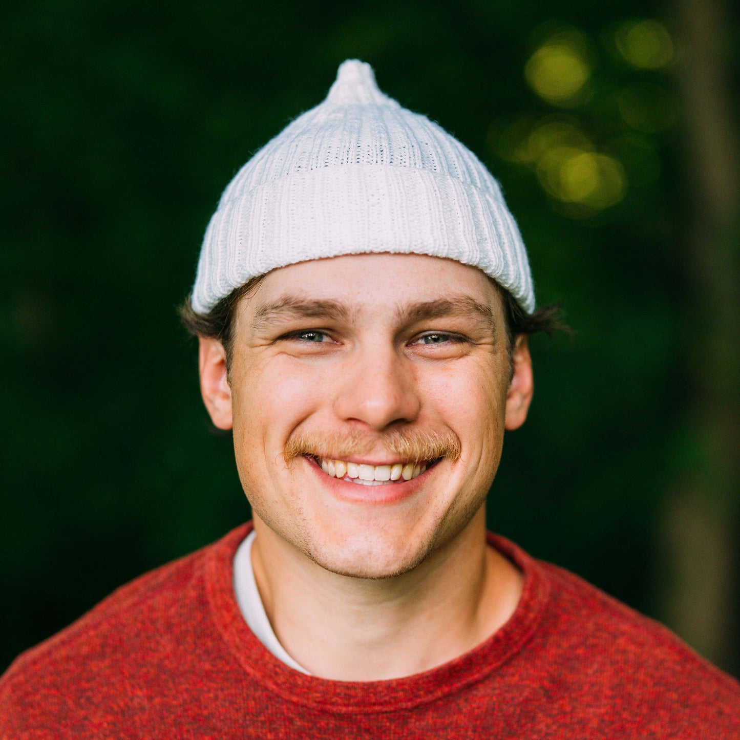 Hand knit pointy wool beanie, white, portrait