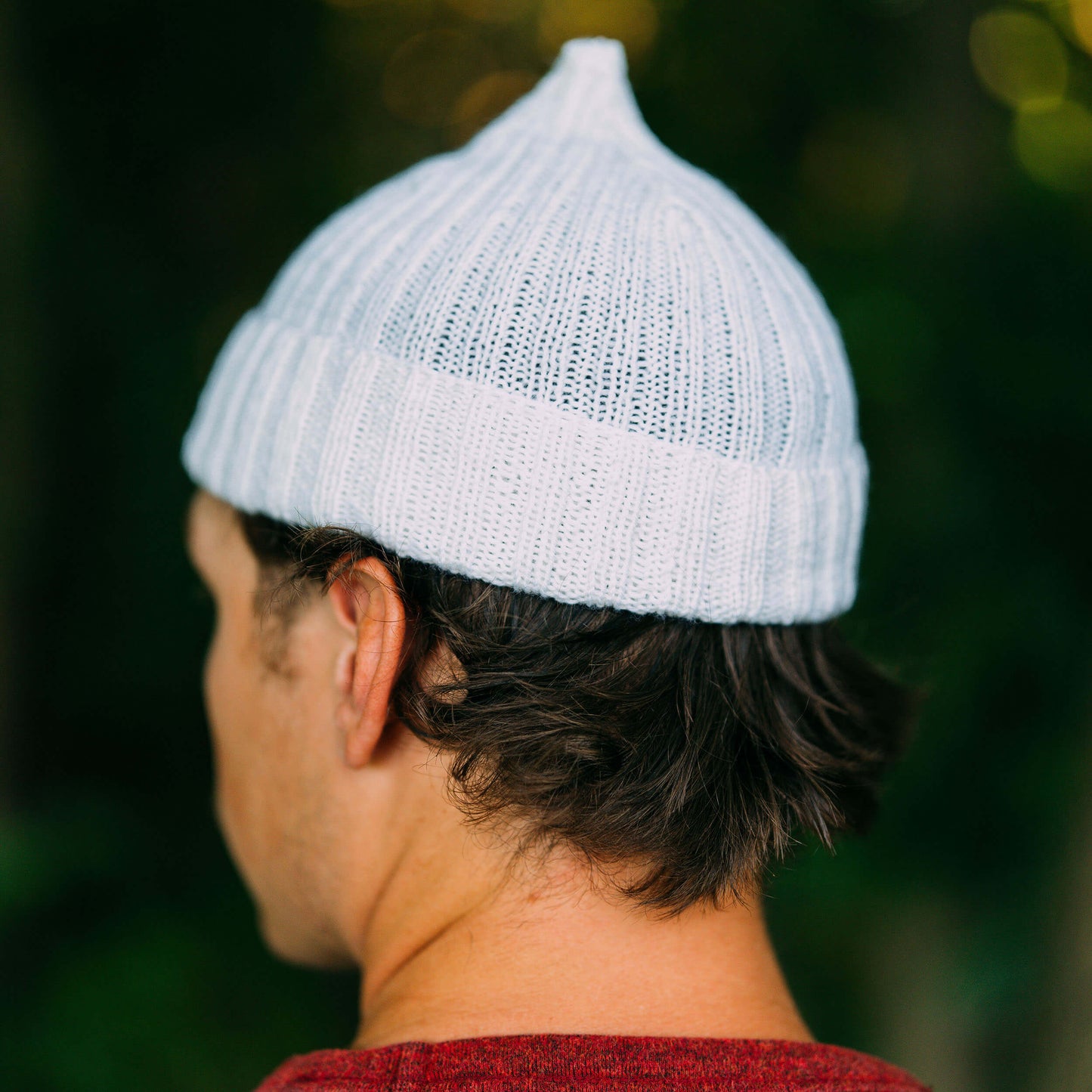 Hand knit pointy wool beanie, white, back view