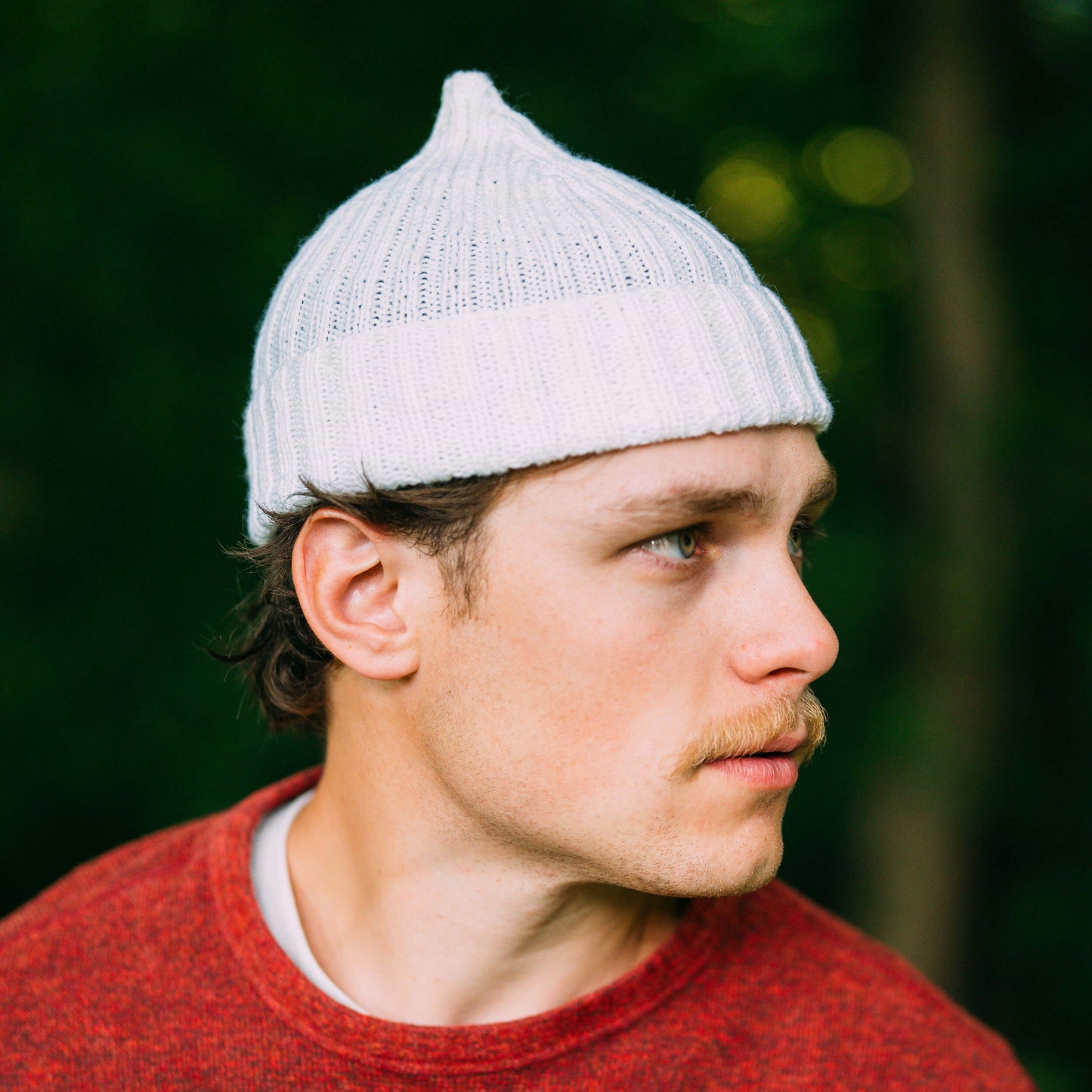 Hand knit pointy wool beanie, white, side view