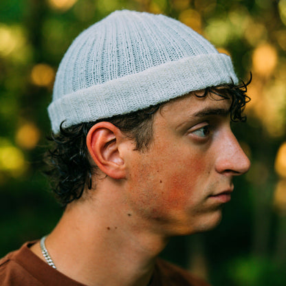 Hand knit wool beanie, white, side view