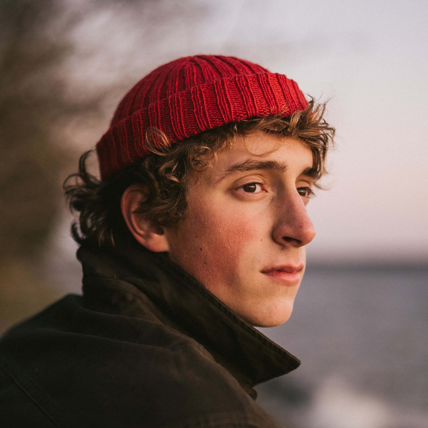 Hand knit wool beanie, red, portrait
