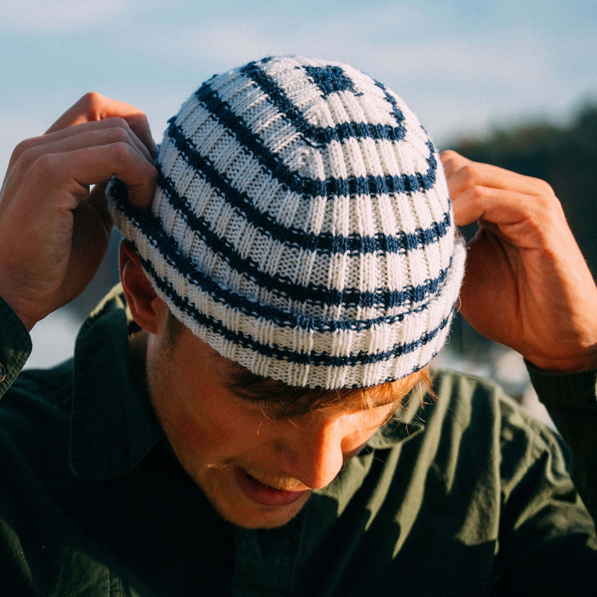 White and navy striped wool beanie, top view