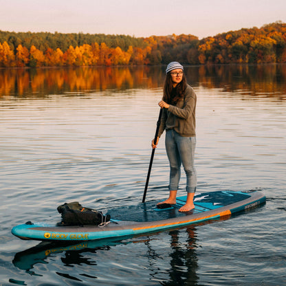 White and navy striped wool beanie, on sup board