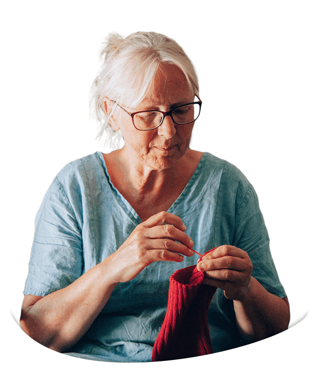 Mom knitting a red beanie